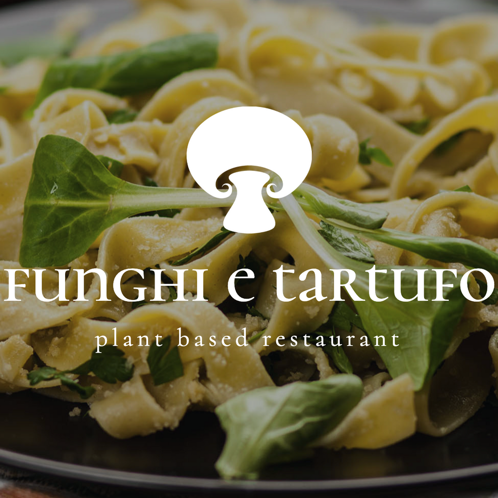A close-up of a plate of pasta with green vegetables and herbs, overlaid with a white mushroom logo and the text 'FUNGHI e tartufo' and 'plant based restaurant'.