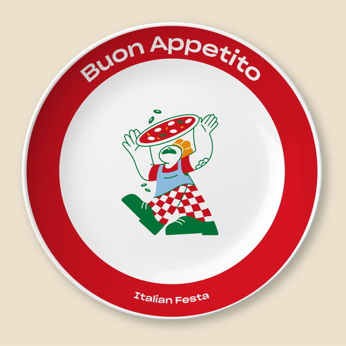 A round white plate with a bold red rim, featuring the Italian phrase 'Buon Appetito' in white at the top and 'Italian Festa' at the bottom. The center contains a colorful cartoon illustration of a pizza character wearing a red-and-white checkered apron and pants, set against a light beige background.
